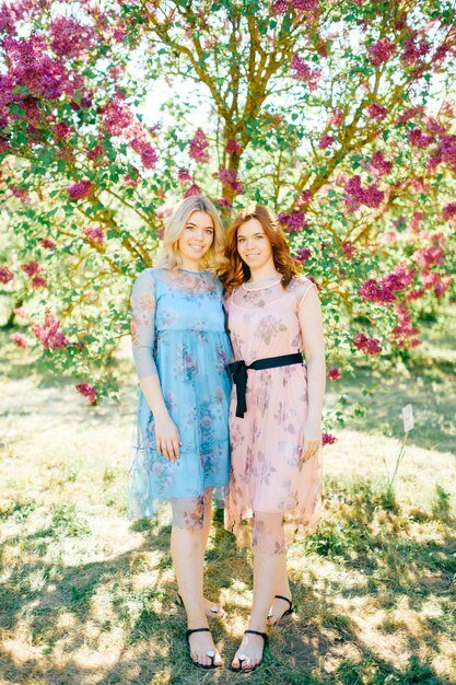 A split image showing the same Shein floral midi dress styled in two different ways: on the left, it's paired with white sneakers and a denim jacket for a casual look; on the right, it's paired with strappy heels and a clutch for a more dressed-up look.