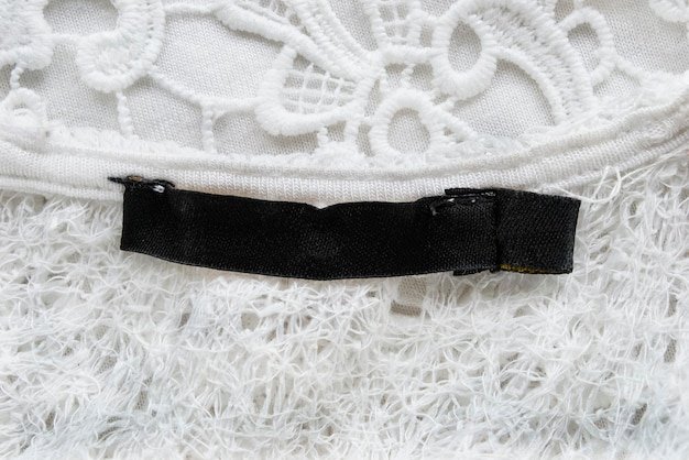 A close-up shot of a Shein corset top in black lace, showcasing its intricate details and adjustable straps. The background is a soft, neutral color to highlight the top's texture.