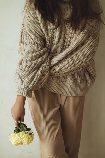 Close-up shot of a Shein outfit consisting of a cream-colored knit sweater, black tailored pants, and delicate gold jewelry. The focus is on the texture of the sweater and the structure of the pants, highlighting the expensive feel of the ensemble.