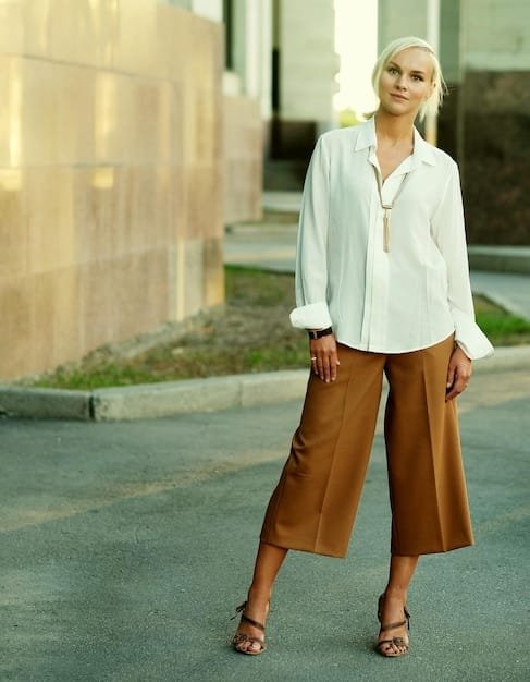 A woman dressed in Shein wide-leg pants with a high-waisted fit, paired with a tucked-in silk blouse, a tailored blazer, and high heels, showcasing an elevated workwear style.