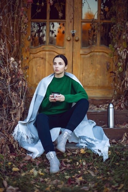 A plus-size woman wearing Shein leggings and an oversized sweater. She is accessorized with a beanie and comfortable sneakers. The background is a cozy living room setting, emphasizing the relaxed and comfortable vibe of the outfit.
