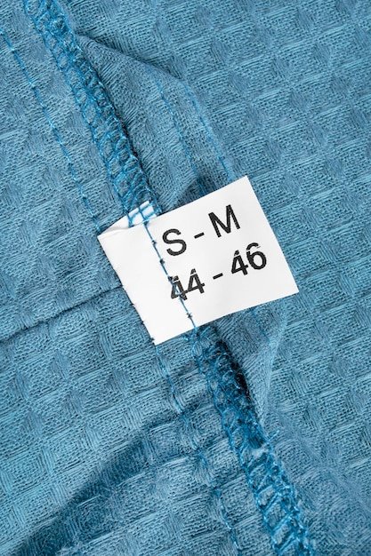 A close-up of a Shein plus size jean's size tag, showing the measurements in both inches and centimeters. The focus is on the detailed measurements provided.
