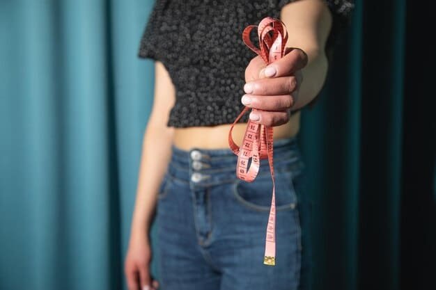 A close-up of a measuring tape being used to measure a woman's waist. The focus is on the tape aligning with the waistline, emphasizing the accuracy needed when taking measurements for online clothing purchases.