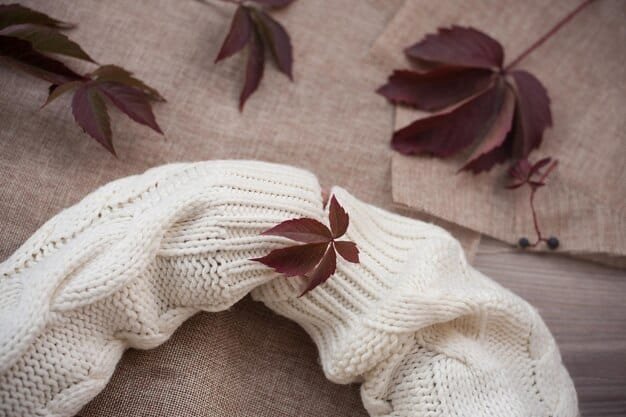A close-up shot showcasing various earthy neutral fabrics, including a chunky knit sweater in beige, linen pants in tan, and a silk scarf in cream, all arranged to highlight their textures and subtle color variations. The image emphasizes the tactile and visual richness of the neutral palette.