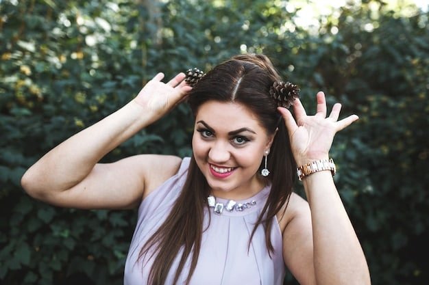 A woman with long hair wearing a pearl-encrusted hair clip from Shein, smiling at the camera with a blurred background of a park.