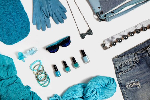 A close-up shot of different Shein workwear items laid out on a flat surface, including a white blouse, a navy blazer, black tailored pants, and a pencil skirt. The focus is on the texture and fabric of the clothing.