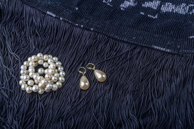 A close-up of Shein earrings showcasing different styles: small gold hoops, pearl studs, and colorful beaded drop earrings displayed against a velvet jewelry box.