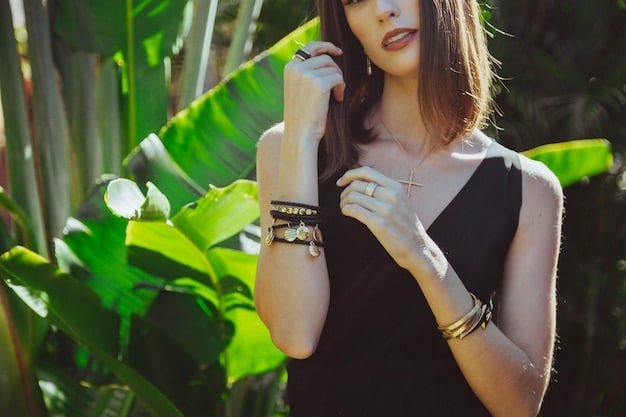 A hand model wearing stackable gold rings and a delicate bracelet from Shein, showcasing a stylish, layered jewelry look against a blurred background.